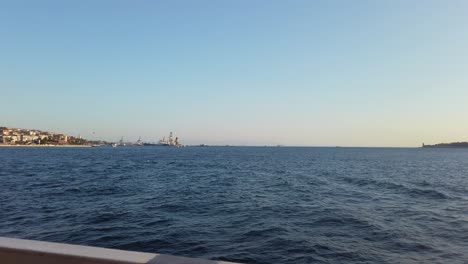 Evening,-cinematic-slow-mo,-the-view-of-the-Bosphorus-from-a-ferry-sailing-along-Istanbul's-iconic-waterway