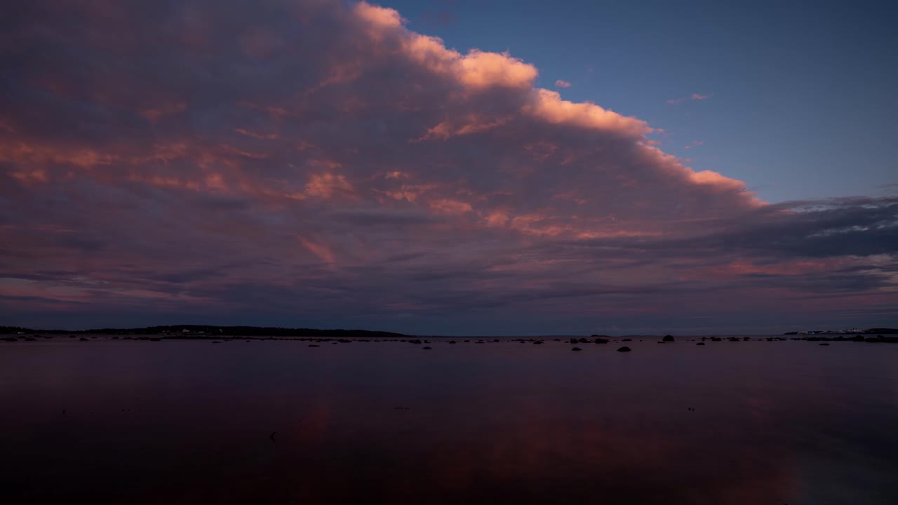 Time lapse footage of coming clouds getting dark just after sunset