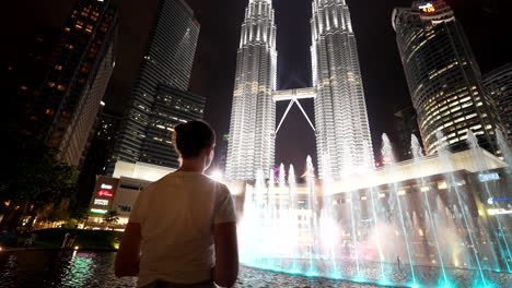 spectacular fountains dance with grace, mirroring the towers’ face