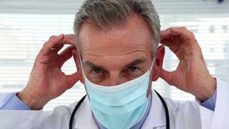 doctor putting protective mask on