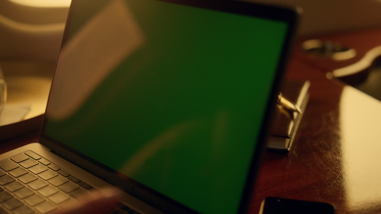 Closeup chroma key laptop in luxury aircraft. Passenger using mockup device.