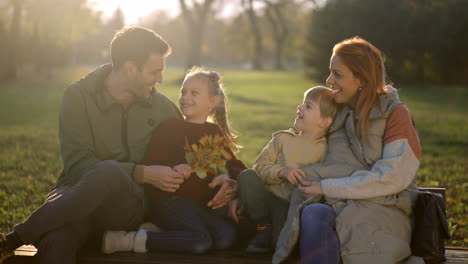 a family enjoying quality time together in the park during autumn