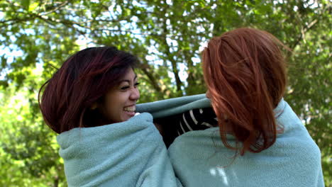 pretty friends wrapped up in blanket