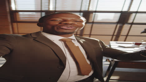 Handsome-Black-Businessman-Video-Calling-in-Office