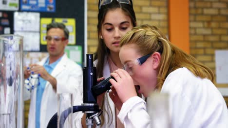 schoolkids doing experiment on microscope 4k