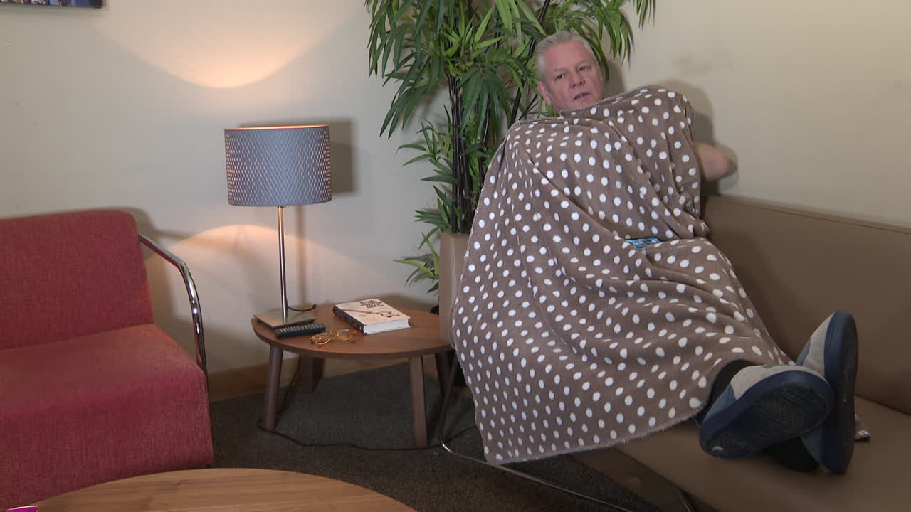 Man Wrapped in Blanket on Couch