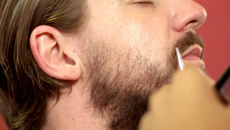 man getting his beard trimmed with scissors 4k