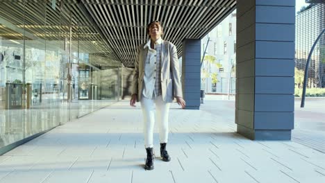 carefree woman dancing happily outdoors in the financial district.