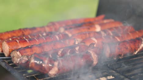 grilling tasty sausages on barbecue grill