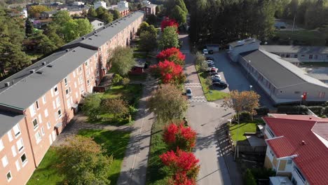 small town in red autumn foliage, aerial reverse