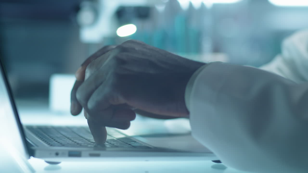 Hands of Lab Scientist Typing on Laptop