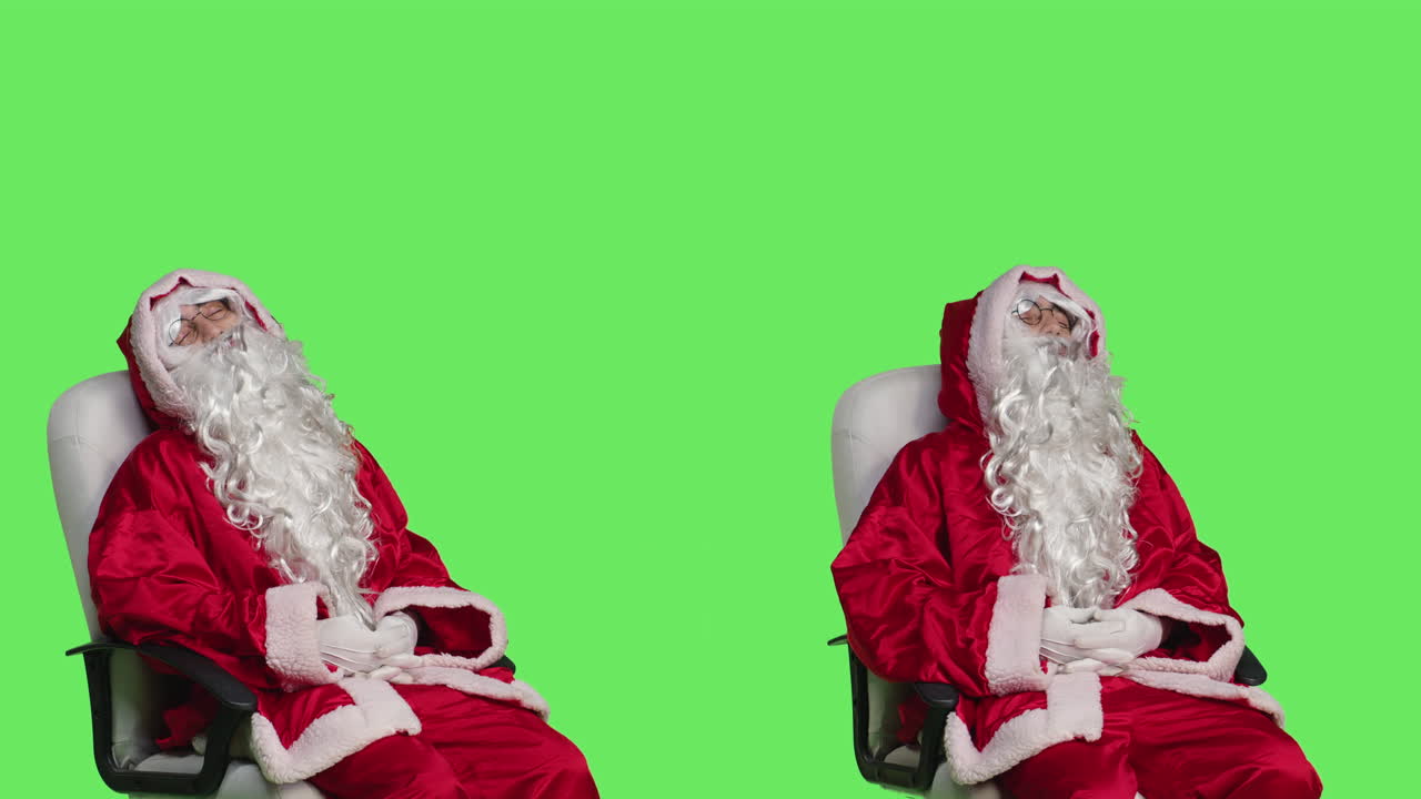 Two Santas sleeping on green screen