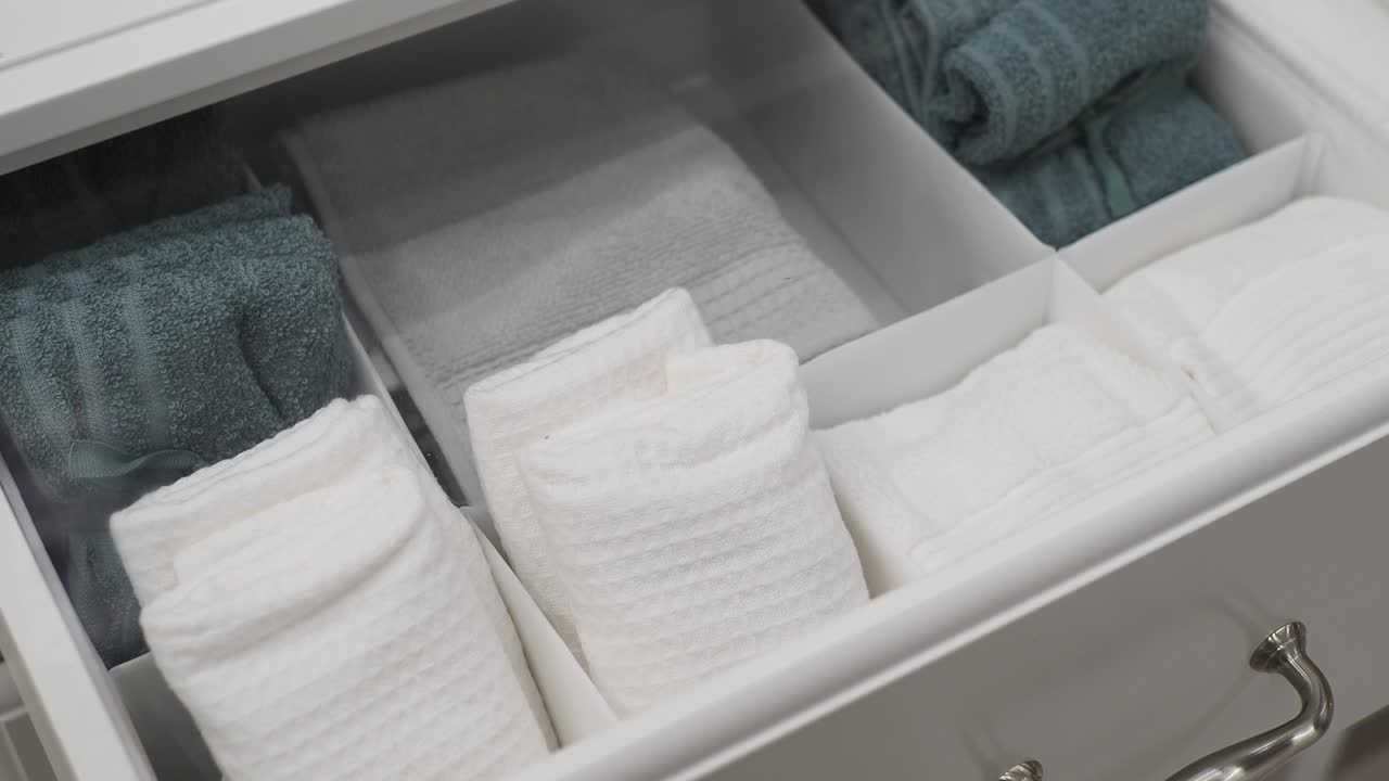 Organized Bathroom Drawer with White and Teal Towels