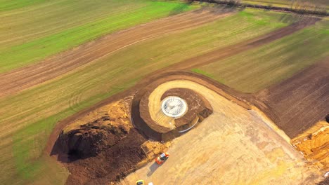 aerial topdown of constructing wind turbine ground foundation in a field