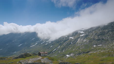 ride near the picturesque mountain landscape of norway drive past a lone wooden house view from car