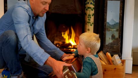 father teaching his son to play guitar in living room at home 4k