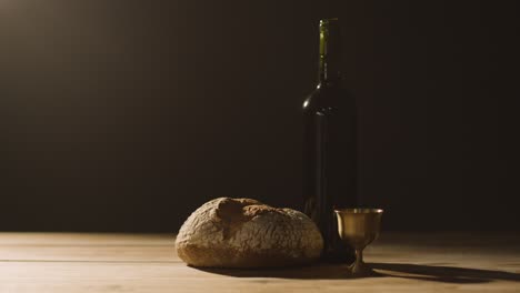 Religious-Concept-Shot-With-Chalice-Bread-And-Wine-On-Wooden-Altar-With-Pool-Of-Light-4