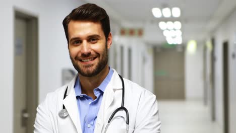 portrait of smiling male doctor in corridor