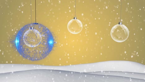 Colorful-baubles-hanging-decorations-and-snow-falling-on-winter-landscape-against-yellow-background