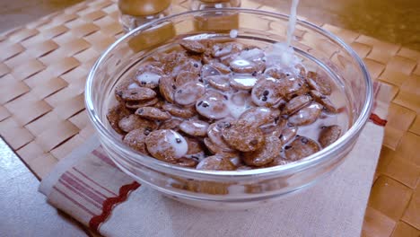 Crispy-chocolate-flakes-in-a-bowl-for-a-morning-delicious-breakfast-with-milk.-Slow-motion-with-rotation-tracking-shot.