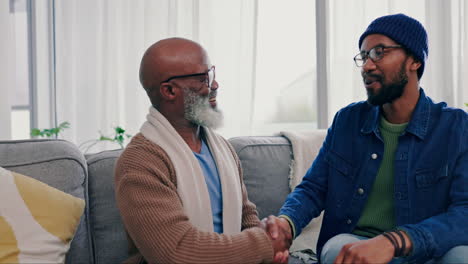 father, son and handshake in home with bonding