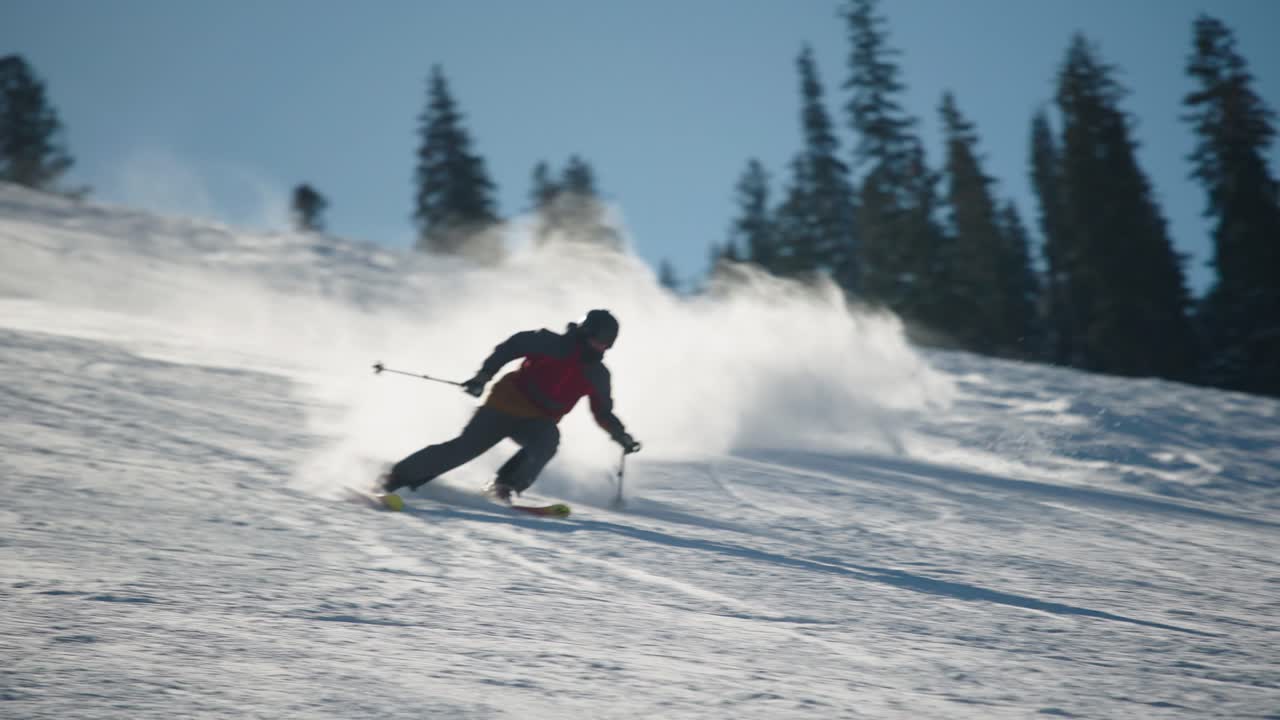 A skier on a nice day skiing fast on a groomed run in Big Sky Montana