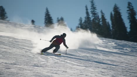 a skier on a nice day skiing fast on a groomed run in big sky montana