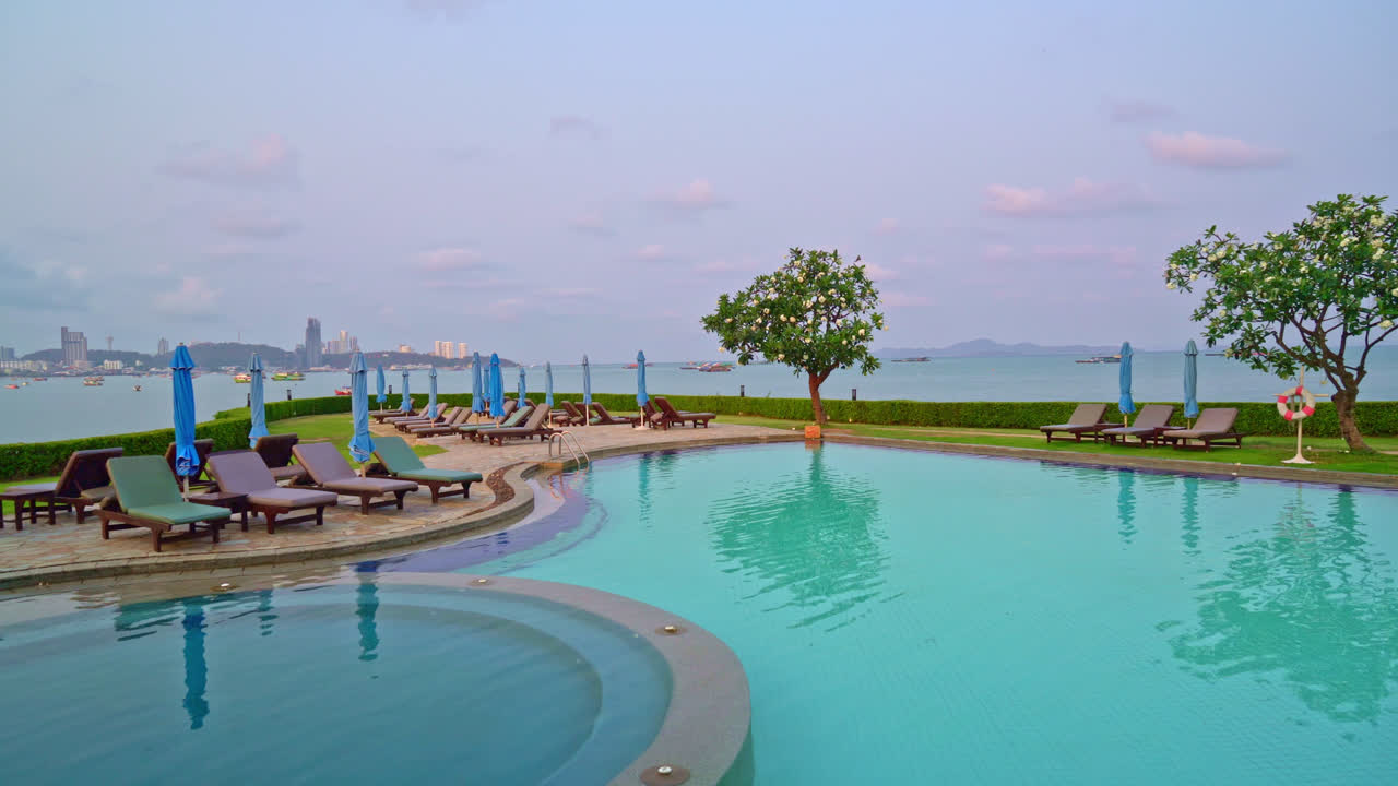 chair pool  or bed pool and umbrella around swimming pool with sea background - Holidays and vacation concept