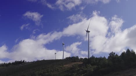 a series of wind turbines in the mountains