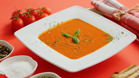 Tomato-soup-in-plate-with-green-leaf