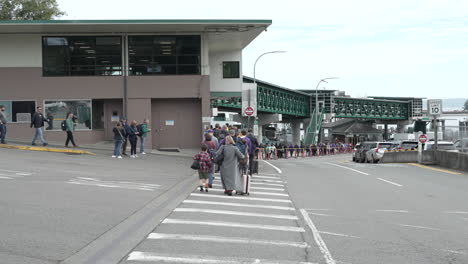 people waiting in line at a ferry terminal