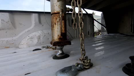 macro of descending goose neck trailer on the ball hitch with hanging chains