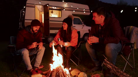 caucasian friends enjoying together a bottle of bear