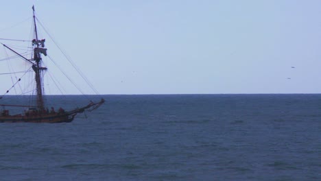 A-tall-masted-ship-sails-on-the-ocean-without-sails-unfurled-1