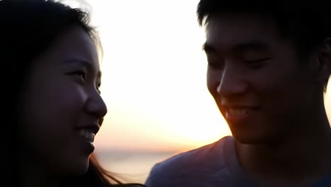 a romantic sunset: capturing the joyful connection between two individuals just before sunset, highlighting their shared smiles and affection in a beautiful natural setting