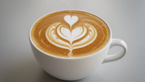 latte,art,coffee,heart,design,creamy,beverage,caffeine,warmth,froth,drink,aroma,smooth,texture,comfort,savor,presentation,brew,cup,espresso,craft,love,foam,delight,engagement,indulgence,mocha,pattern,enjoyment,sip,serenity,morning,rich,flavor,visual,artistry,scene,inspiration,reflection,happiness