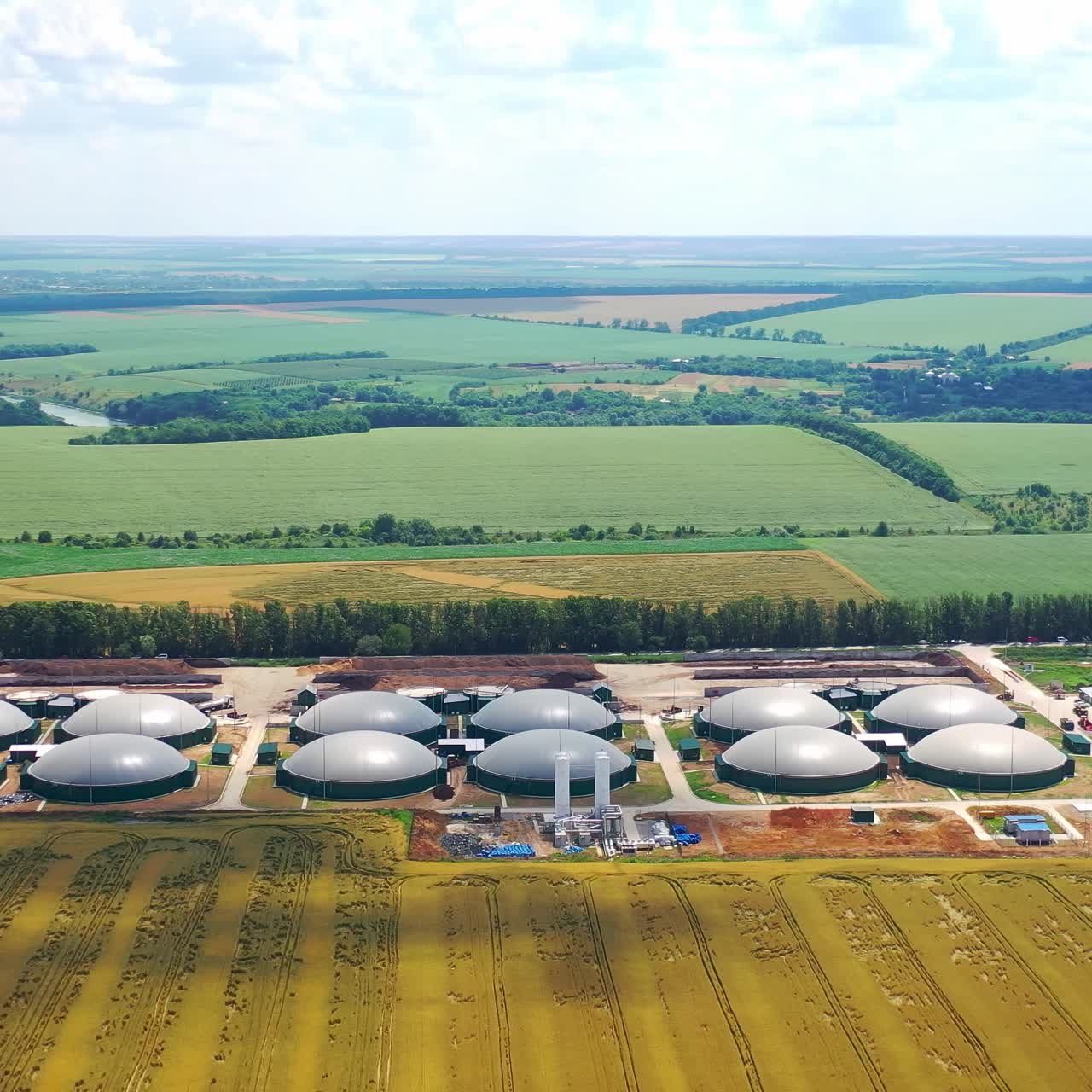 Production of sustainable fuel called bio gas. New factory in field. View from above. Ecological production concept