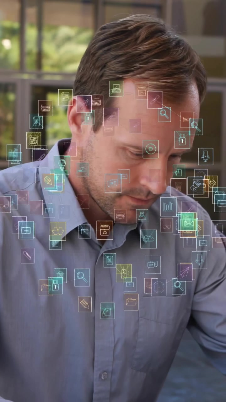 Man reading documents gesturing over floating icons expanding into business web for data analysis