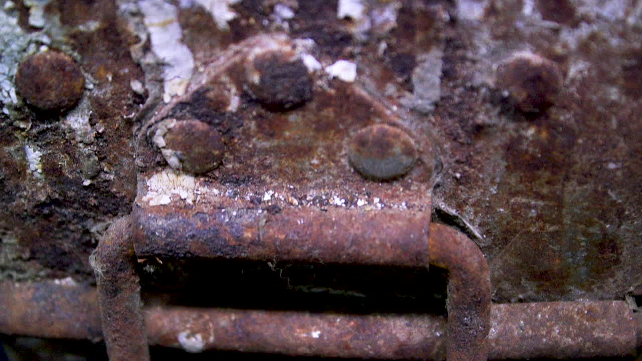 Locking mechanism on an old rusty canister used for shipping 35 millimetre films. Canister made by Goldberg Bros