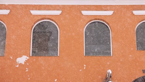 heavy snow falling at the old town with brick wall structures in brasov, transylvania, romania