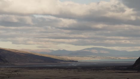 new zealand autumn season landscape with mountains during rain, with cloud moving fast in the mountains