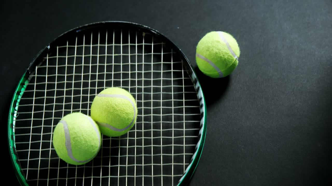 Tennis balls and racket in studio 4k