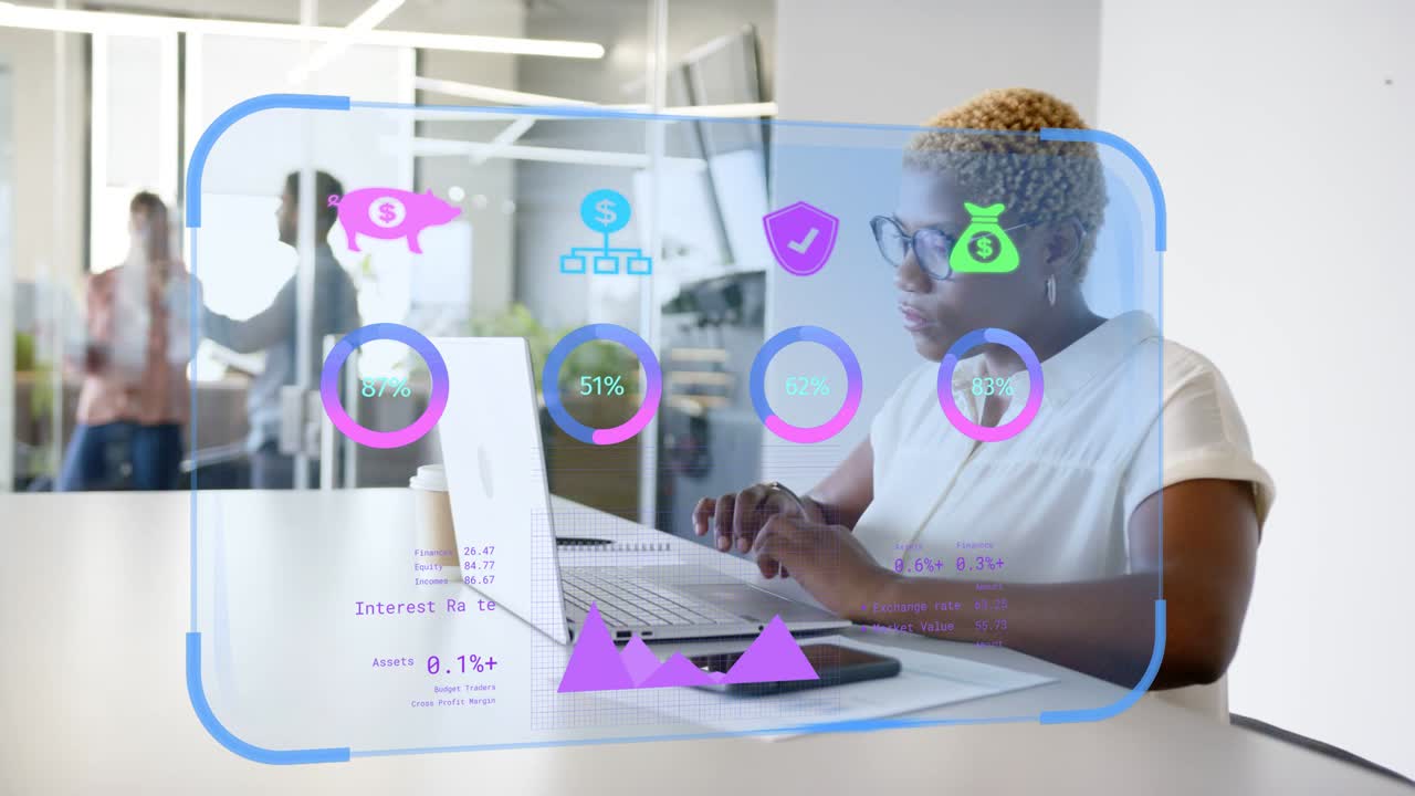 Analyst inputting data on laptop, updating AR finance rings, icons and purple graph for review