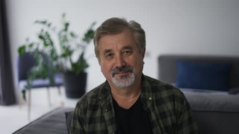 Portrait-of-one-cheerful-grandfather-relaxing-indoor