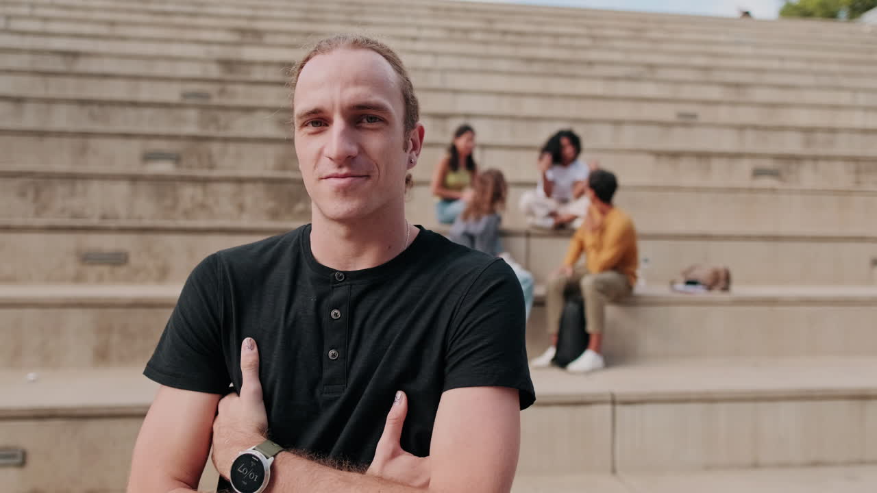 Сheerful European boy, male student with his friends in the background
