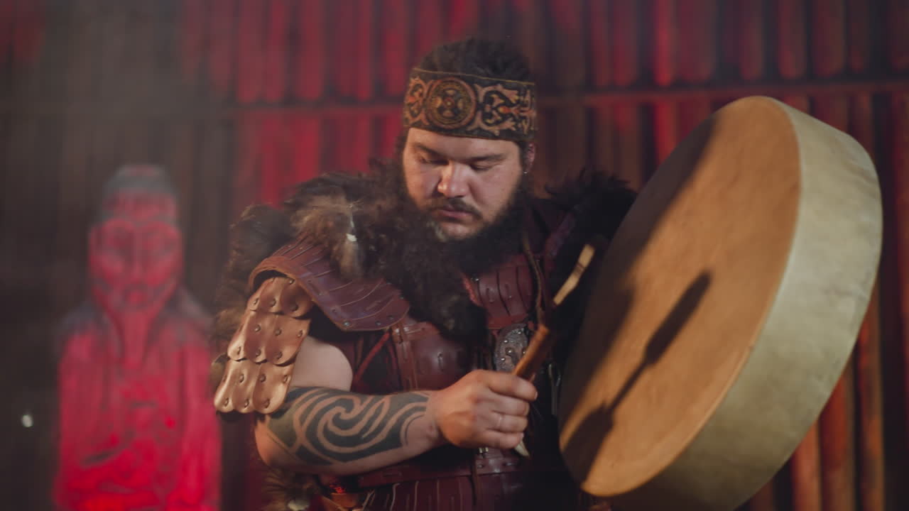 Asian man with tattooed arms conducts evil spirits placating