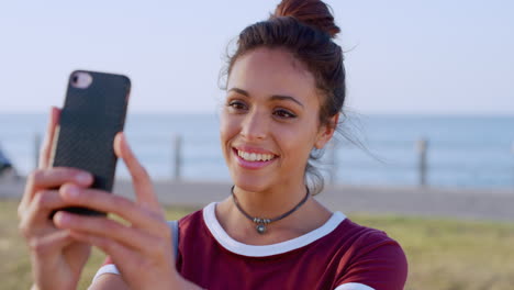 Woman,-phone-and-selfie-of-face-at-beach-promenade