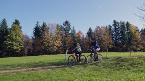 young couple on their cycling route through the scenic landscape, tracking shot