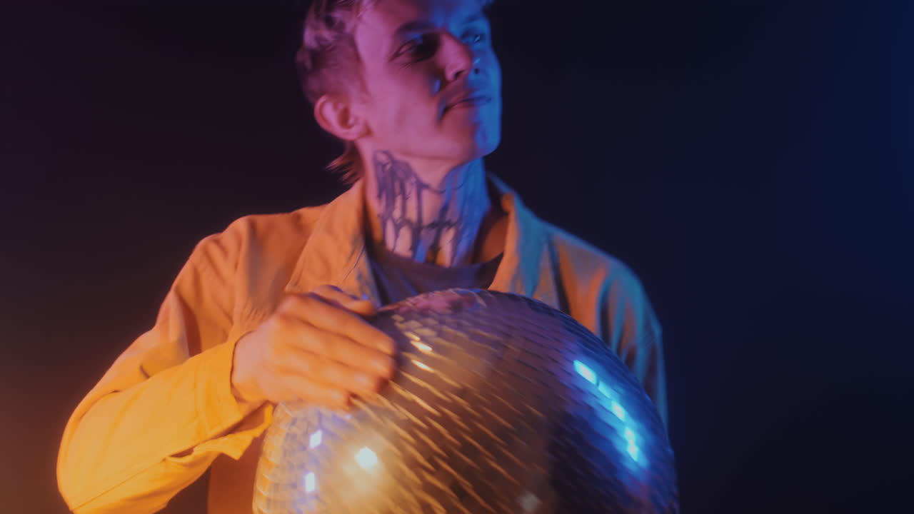 Male DJ with Disco Ball Clubbing in Neon Light