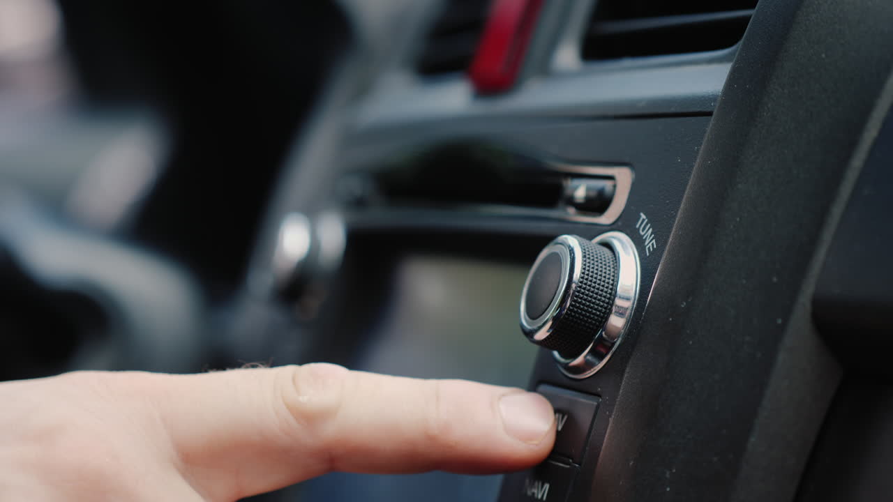 남성 손은 자동차 라디오 클로즈업 샷의 튜닝을 조정합니다.